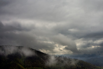 Storm coming in over hills.