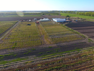 Fototapeta premium Frameworks of greenhouses, top view. Construction of greenhouses in the field. Agriculture, agrotechnics of closed ground