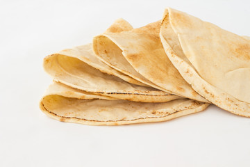 Tortilla, cakes made of wheat flour on a white background