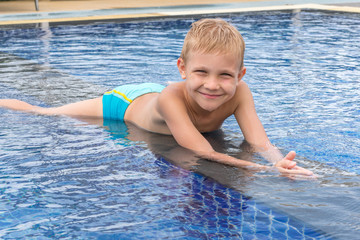 Boy swimming and playing in a pool