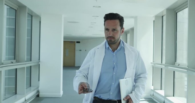 Medical professional checking smartphone on way to meeting
