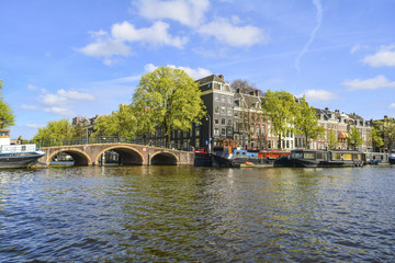 Fototapeta na wymiar Amsterdam city with boats on canal, Netherlands