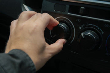 Close-up of man open switch air in car