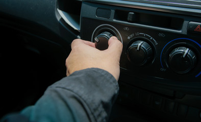 Close-up of man open switch air in car