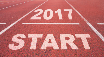 Word Start written on an asphalt road
