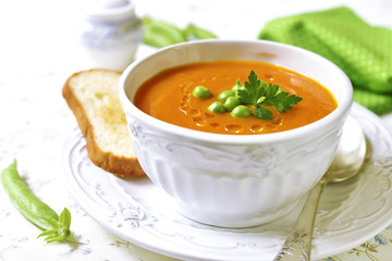 Carrot creamy soup with green pea.