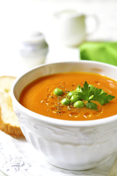 Carrot creamy soup with green pea.