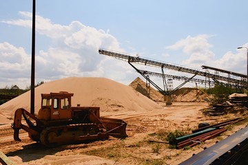 Conveyor belts and sand heaps. Construction industry. Sand quarry. Horizontal  photo.