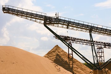 Conveyor belts and sand heaps. Construction industry. Horizontal  photo