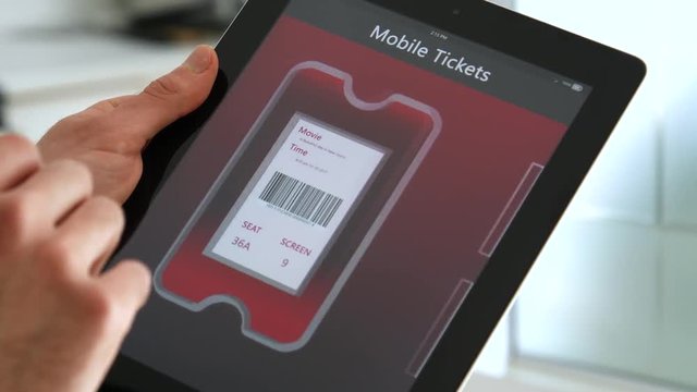 Ticket for seeing a movie at the theatre showing on a tablet.