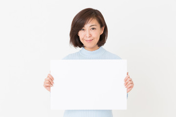 Fototapeta premium ホワイトボードを持つミドル女性 笑顔