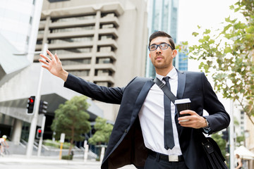 Young businessman hailing for a taxi