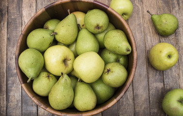 Fototapeta na wymiar Apples and pears in wooden bowl