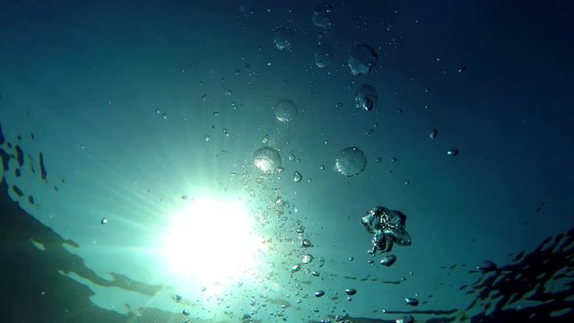 Underwater GoPro shots, sun rays through the water, splashes and bubles