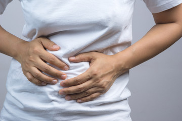 Woman putting her hands for belly or stomach ache