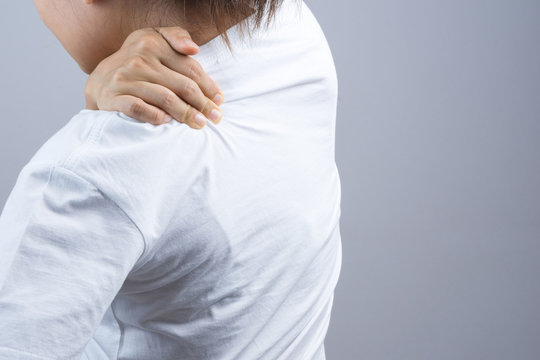 Woman putting her hand for neck and shoulder pain