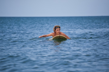 The woman surfing at the sea, summer vacation