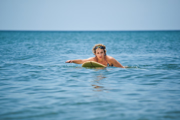 The woman surfing at the sea, summer vacation