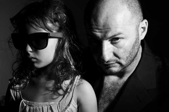 Father and daughter in gang style, dark light