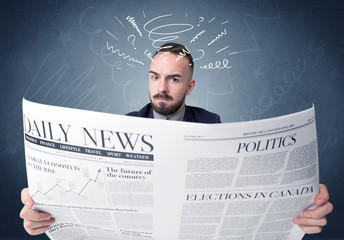 Businessman reading newspaper