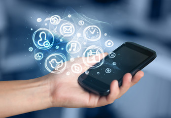 Hand holding smartphone with mobile app choices