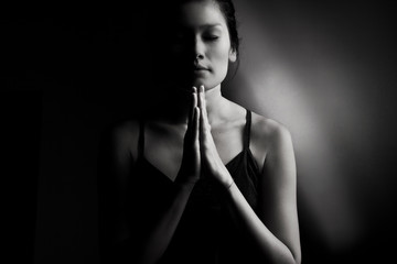 Female prayer on dark 