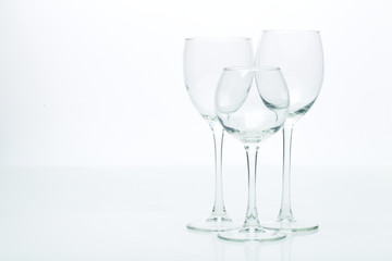 Grapes and three glasses for wine on a white background, studio light