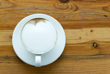 Top view latte coffee on wooden background