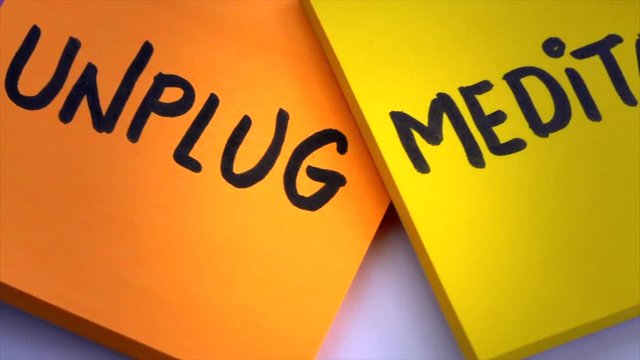 Slow down, unplug and relax concept, text on colorful turning sticky notes