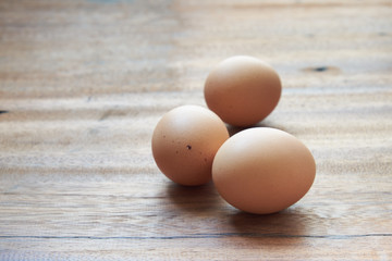 Eggs lay on wooden background. Food ingredient.