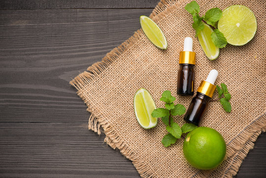 Natural cosmetics for home spa. Bottle of essence oil with fresh limes