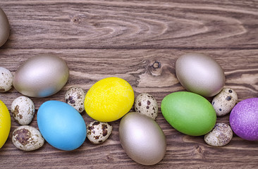 Multicolored easter eggs on wooden background