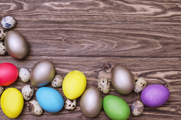 Multicolored easter eggs on wooden background