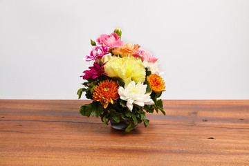 Beautiful bouquet of fresh flowers on wooden table.