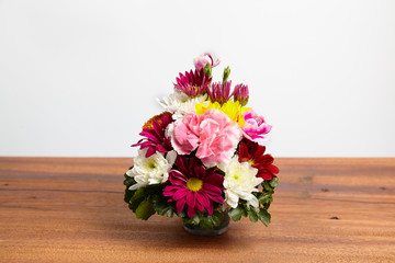 Beautiful bouquet of fresh flowers on wooden table.