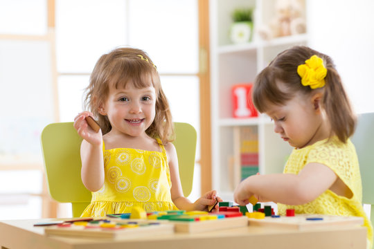 Kids playing block toys in playroom at nursery