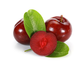 Whole and half ripe purple cherry plums