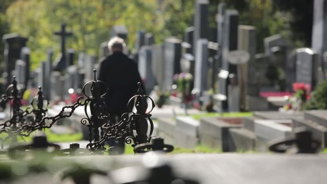 Cemetery in spring with flowers, wreaths and gravestones - 2