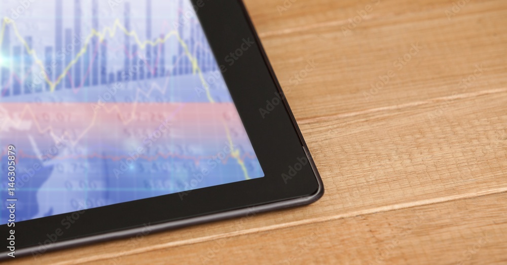 Poster Cropped image of tablet computer on table