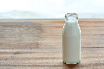 Milk in the bottle on wooden background. a daily drink for healthy.