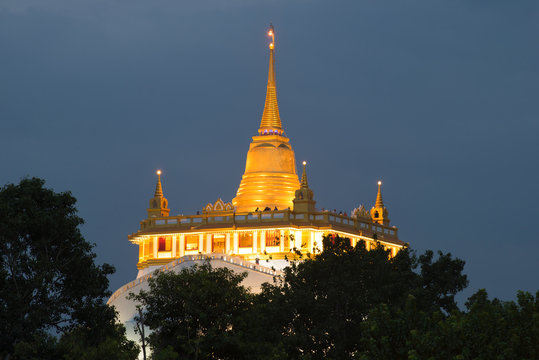 Chedi Temple of the Golden Mountain (Wat Sacket) in the evening twilight close up. Bangkok, Thailand
