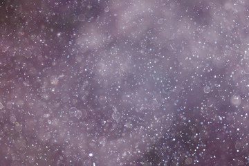 Snowfall texture of snowflakes on blurred background