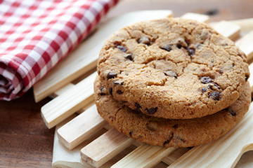 Chocolate chips cookies with milk bottle in background on the wooden table. quick and easy meal in the morning. Close up shot.