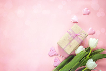Obraz na płótnie Canvas White tulips, hearts and gift box on pink background. Happy mother's day concept.