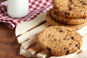 Chocolate chips cookies with milk bottle in background on the wooden table. quick and easy meal in the morning. Close up shot.