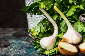 Fresh garlic on rustic wooden table at dark background, front view. Spicy Cooking concept