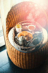 Cozy Breakfast on rustic tray on chair at morning light