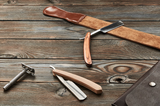 Vintage barber shop razor tools on wooden background