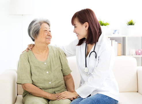 young smiling home caregiver  with senior woman