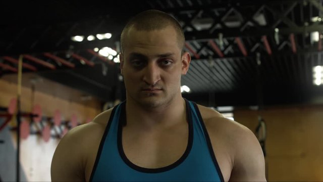 The athlete breathes heavily and looks at the camera